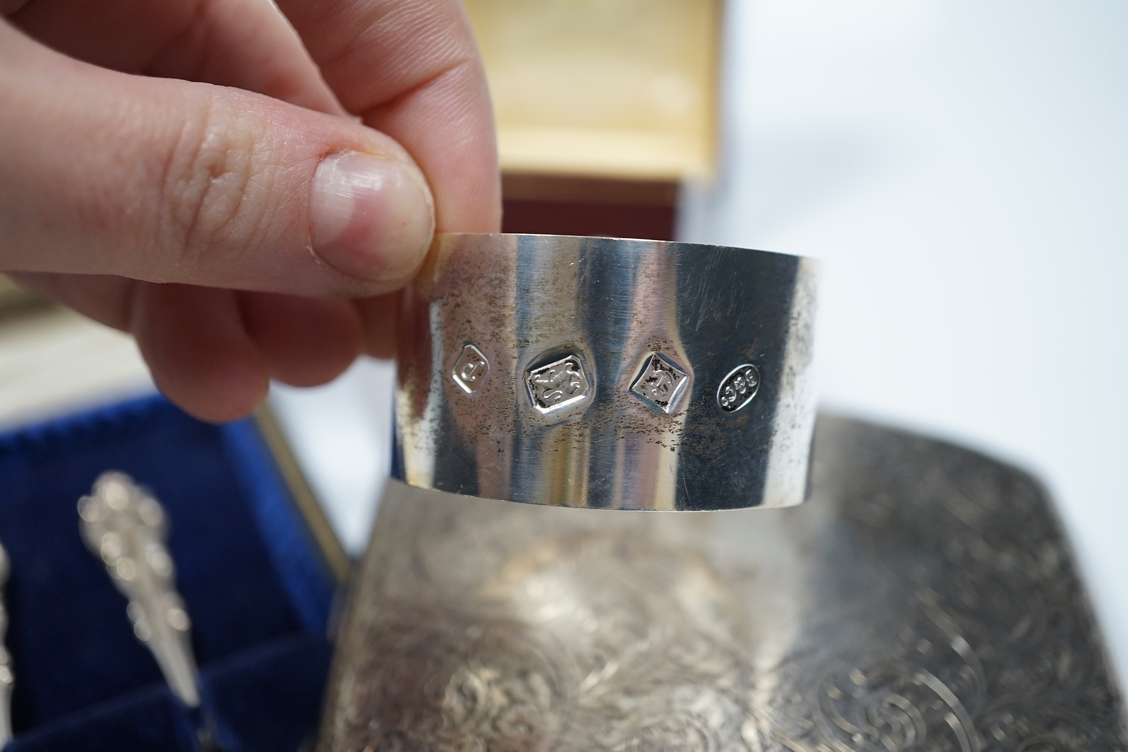A George V engraved silver mounted nail buffer with cover, Birmingham, 1928, 14.9cm, together with a silver cigarette case, a silver napkin ring and a cased set of six silver teaspoons.
